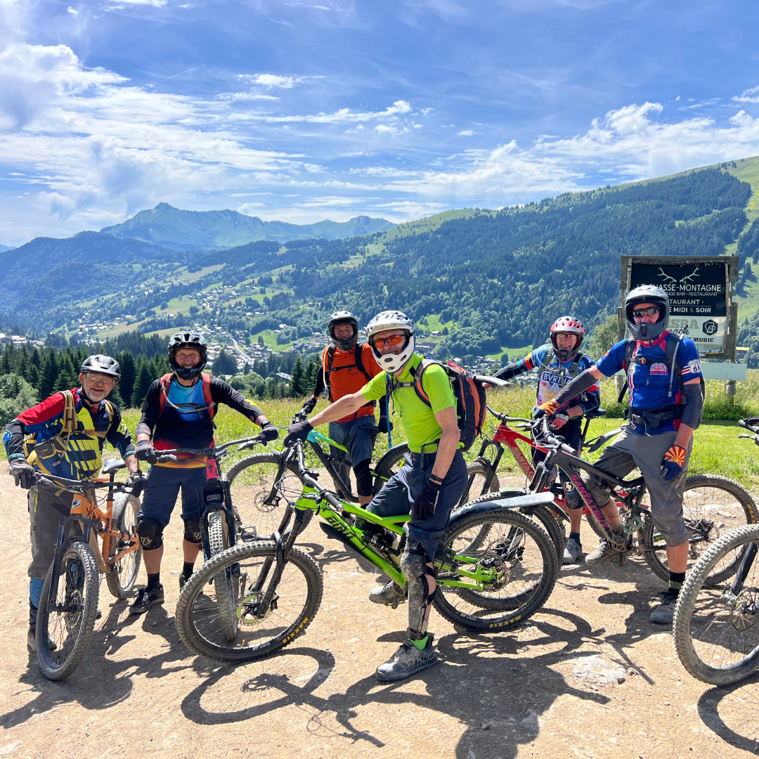 Chalet Aventure guests enjoying mountain biking together on scenic trails in Les Gets, sharing a fun and adventurous group experience in the French Alps.