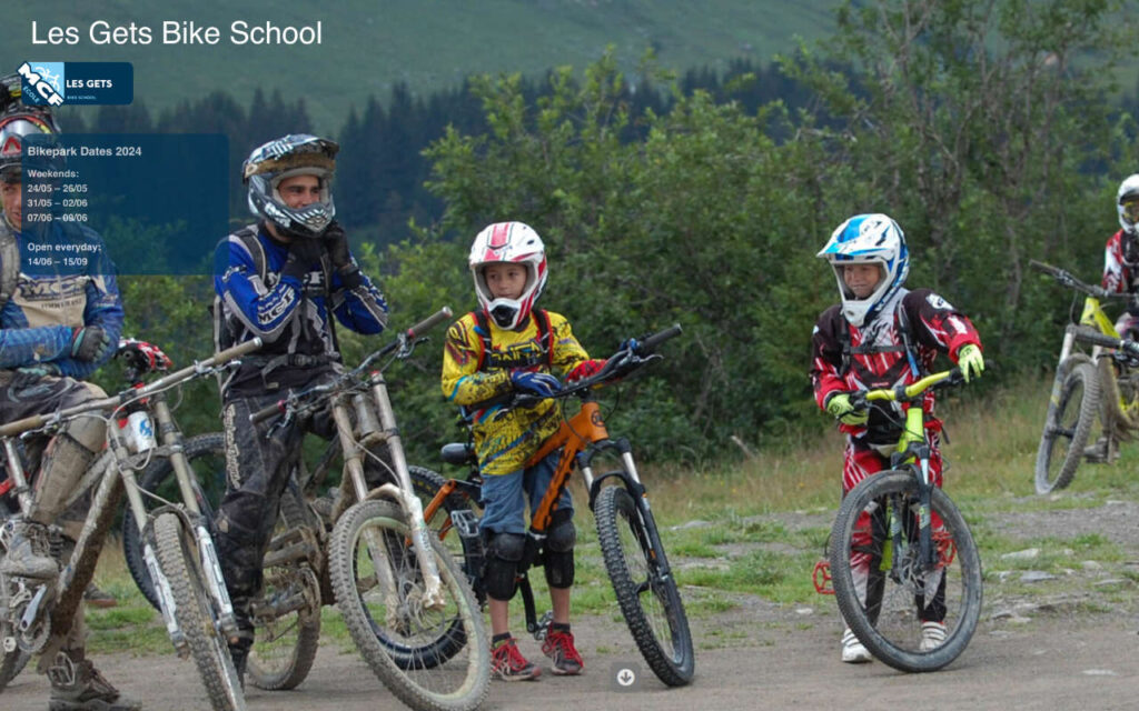 Mountain biking instructor guiding students through scenic trails in Les Gets, France, at Les Gets Bike School.