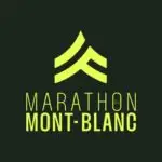 Runners participating in the Chamonix Mont Blanc Marathon trail running race, with the stunning Mont Blanc massif in the background