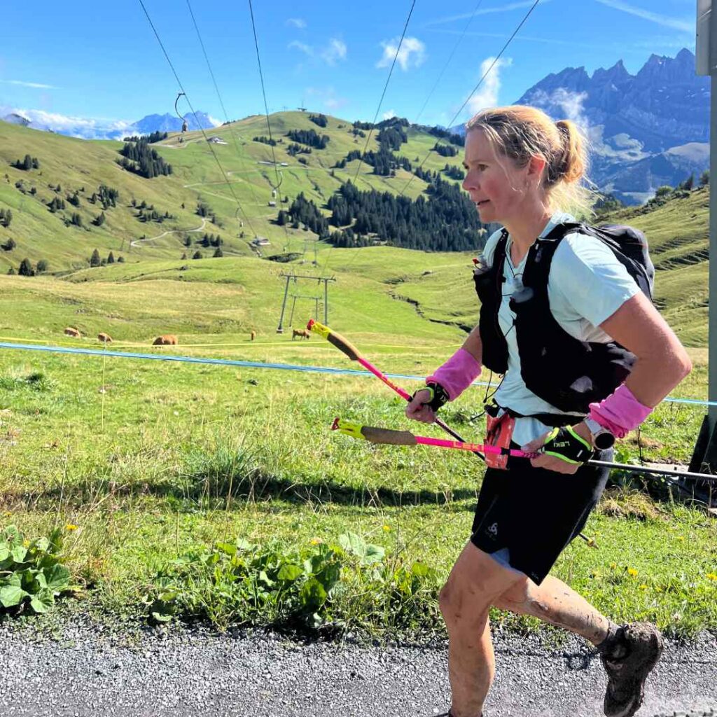 Trail runner on a scenic path at Col du Cou, surrounded by alpine mountains in Les Gets.