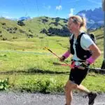 Trail runner on a scenic path at Col du Cou, surrounded by alpine mountains in Les Gets.
