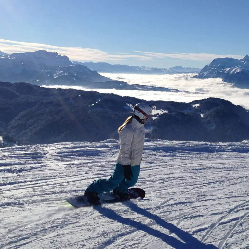 Snowboarder enjoying pristine powder slopes in Les Gets, France