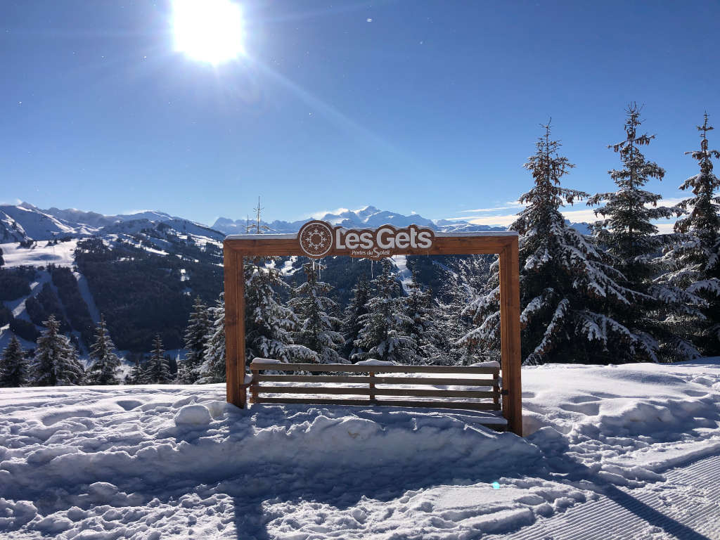 Winter in Les Gets ski resort, snow-covered streets, alpine views, and winter sports activities in the French Alps